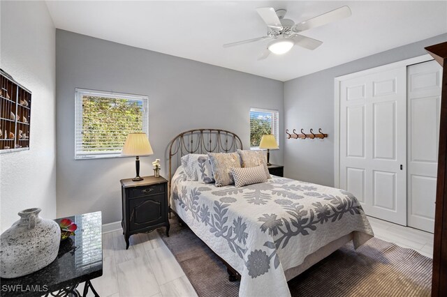 bedroom with multiple windows, a closet, ceiling fan, and light hardwood / wood-style flooring