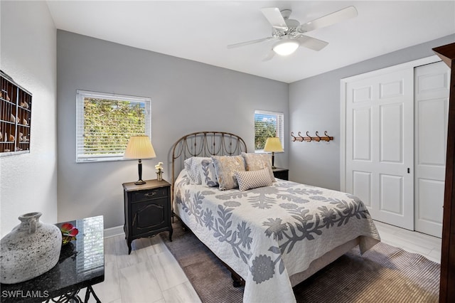 bedroom with a ceiling fan and a closet