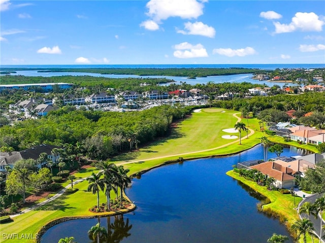 birds eye view of property with a water view and golf course view