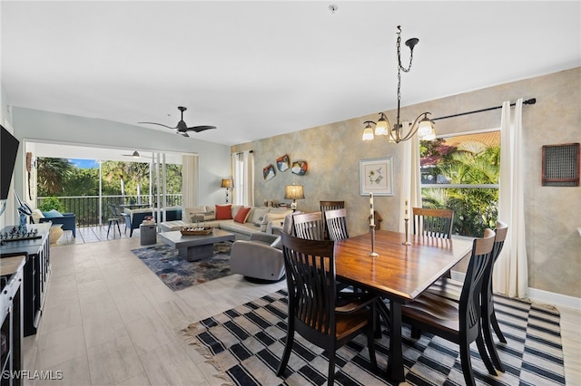 dining area featuring ceiling fan with notable chandelier and light hardwood / wood-style flooring