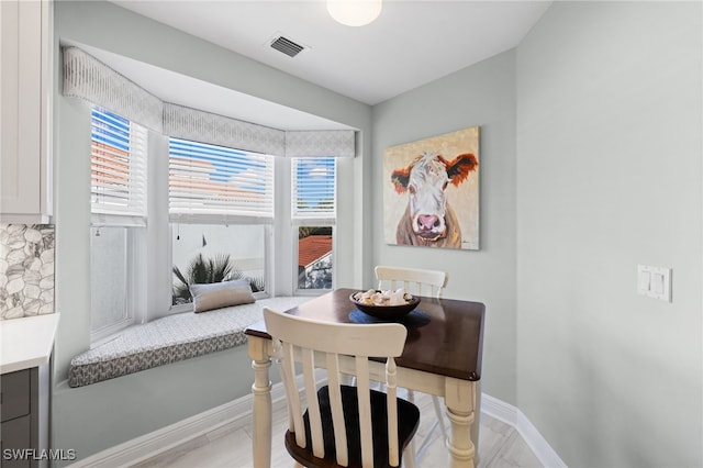 dining space featuring visible vents and baseboards