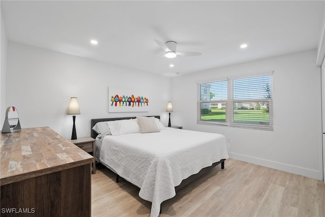 bedroom with ceiling fan and light hardwood / wood-style flooring