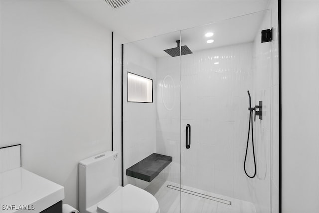 bathroom with toilet, a shower with shower door, and vanity