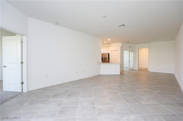 unfurnished living room with light tile patterned floors