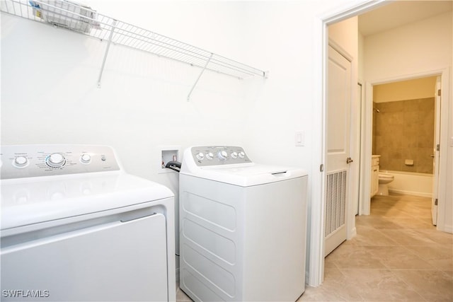 washroom with separate washer and dryer