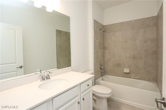 full bathroom featuring vanity, toilet, tile patterned floors, and tiled shower / bath