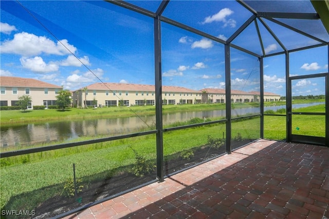 unfurnished sunroom featuring a water view