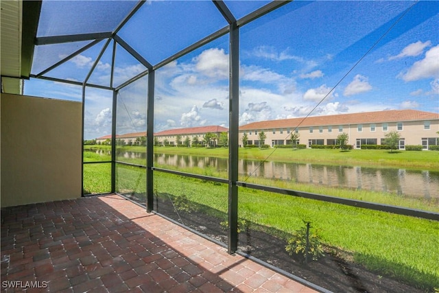 unfurnished sunroom featuring a water view