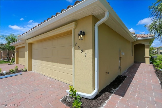 view of side of property with a garage