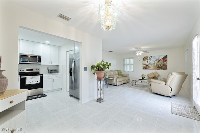 kitchen featuring light tile patterned floors, ceiling fan, stainless steel appliances, and white cabinetry