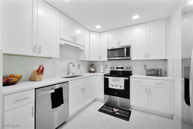 kitchen featuring stainless steel appliances, white cabinets, and sink