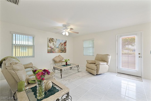 tiled living room featuring ceiling fan