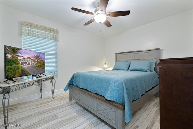 bedroom with ceiling fan and light hardwood / wood-style flooring