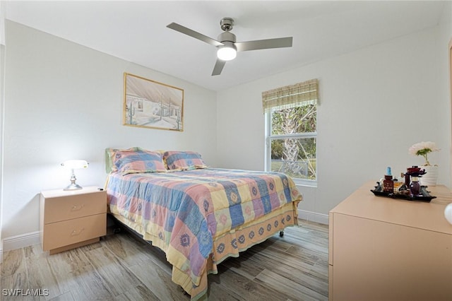 bedroom with ceiling fan and hardwood / wood-style flooring