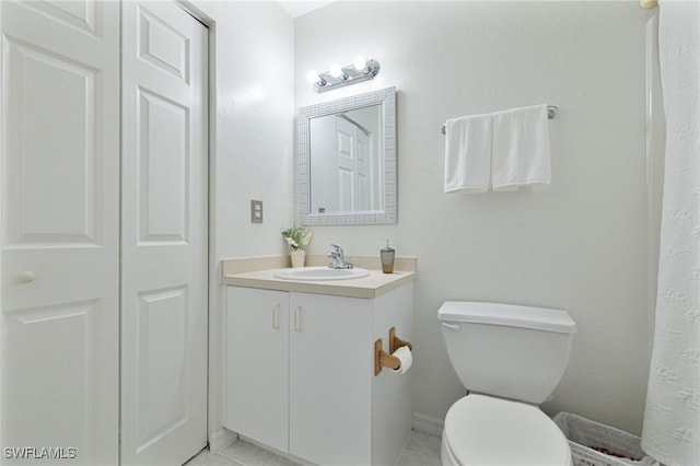 bathroom with tile patterned floors, toilet, and vanity