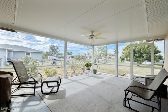 sunroom / solarium featuring ceiling fan