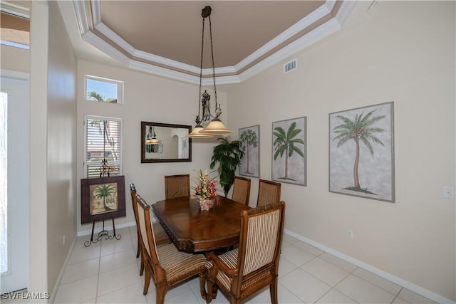 dining area featuring crown molding, a raised ceiling, a high ceiling, and light tile patterned flooring