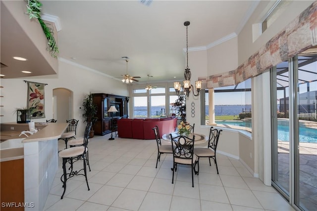 dining room with ornamental molding, ceiling fan with notable chandelier, and light tile patterned flooring