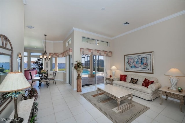 living room with light tile patterned flooring, ornamental molding, and an inviting chandelier