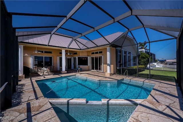 view of pool featuring a lanai, ceiling fan, and a patio area