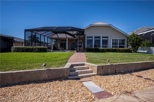 rear view of house featuring a yard and a lanai