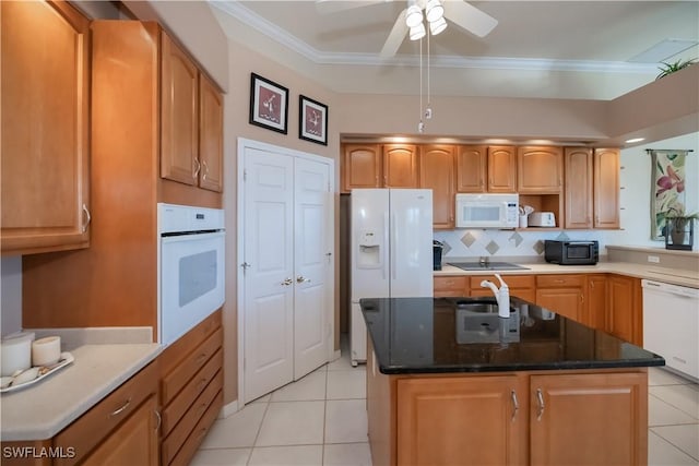 kitchen featuring a kitchen island with sink, ornamental molding, and black appliances