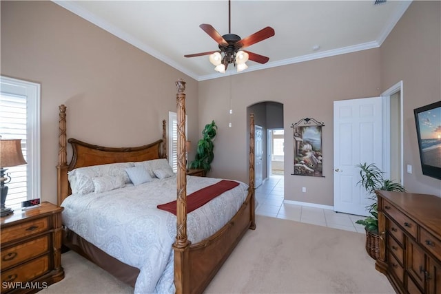 bedroom with ceiling fan, ornamental molding, and light tile patterned floors