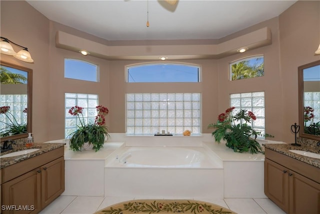 bathroom with vanity, tile patterned flooring, and a bathtub