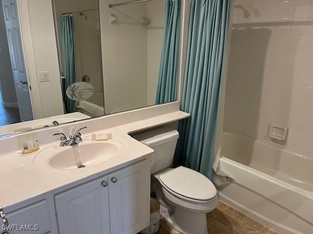 full bathroom featuring toilet, tile patterned flooring, vanity, and shower / bath combo with shower curtain