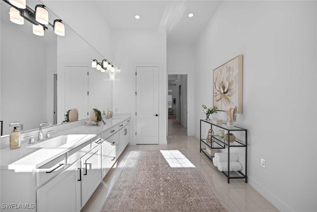 bathroom featuring vanity and a high ceiling