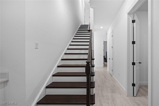 staircase with wood-type flooring