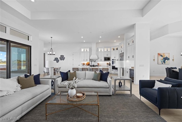 living room with wine cooler, hardwood / wood-style floors, and a notable chandelier