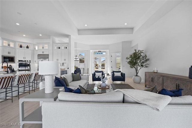 living room featuring french doors and light wood-type flooring