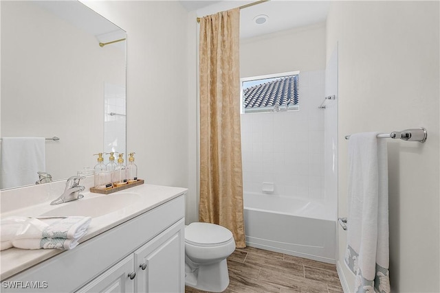 full bathroom featuring shower / bath combo, vanity, and toilet