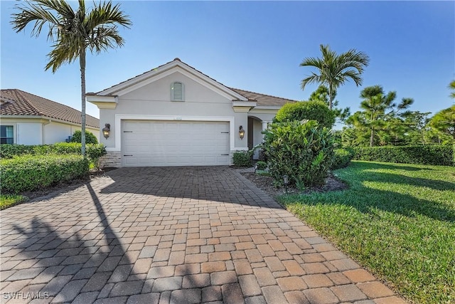 single story home featuring a front yard and a garage