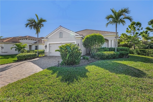 view of front of home with a front lawn and a garage