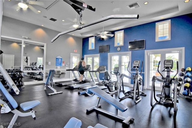 workout area featuring a towering ceiling, ceiling fan, and french doors