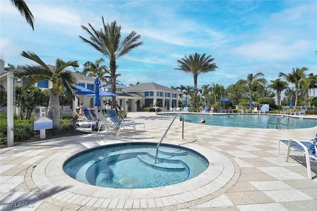 view of pool featuring a community hot tub and a patio