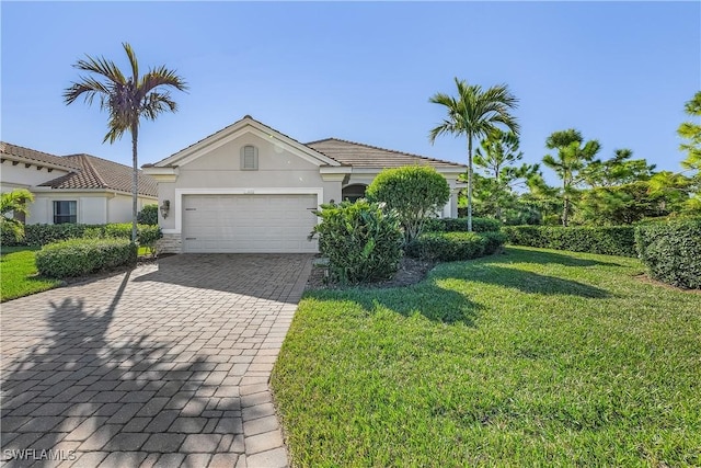 view of front of home with a front yard and a garage