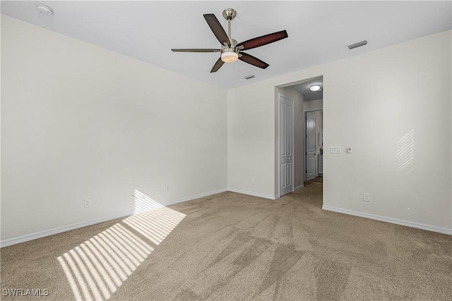 carpeted empty room featuring ceiling fan