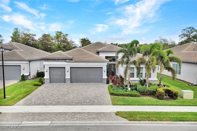 view of front of house with a garage and a front lawn