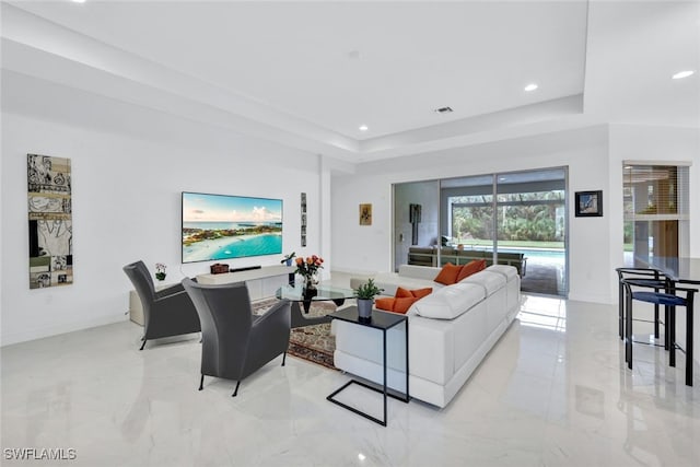 living room with a tray ceiling