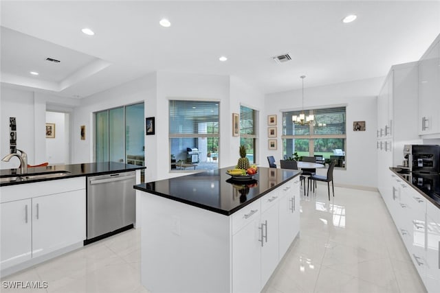 kitchen with white cabinetry, stainless steel dishwasher, and sink