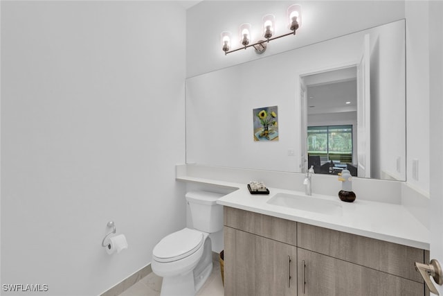 bathroom featuring toilet, tile patterned flooring, and vanity