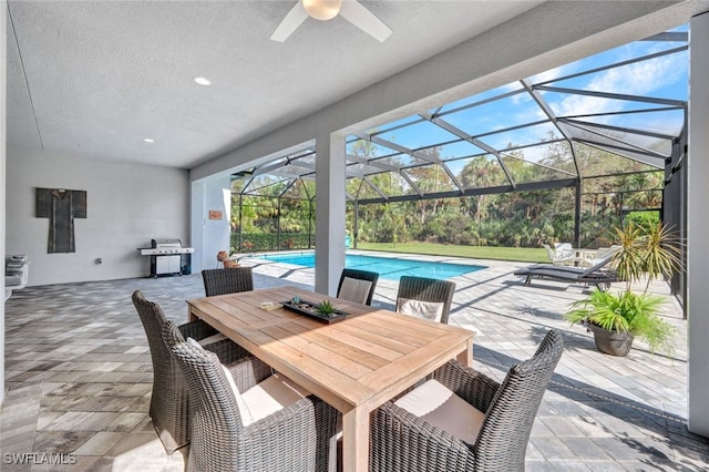 view of patio / terrace with ceiling fan and a lanai