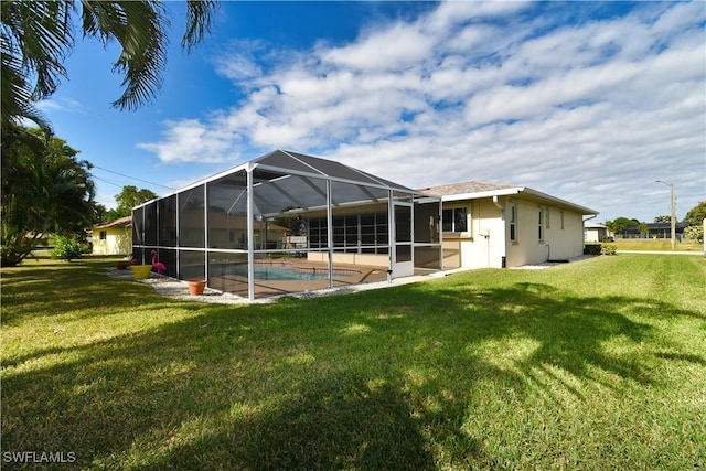 back of property featuring a lawn and glass enclosure