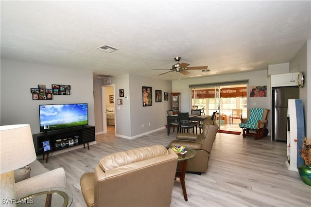 living room with ceiling fan and light hardwood / wood-style floors