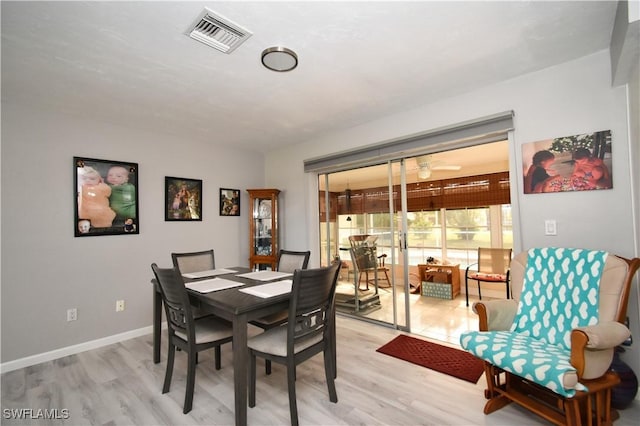 dining area with ceiling fan and light hardwood / wood-style flooring