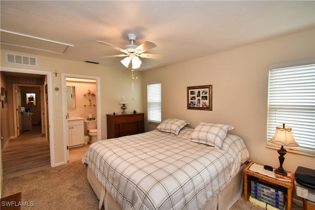 carpeted bedroom featuring ceiling fan and connected bathroom