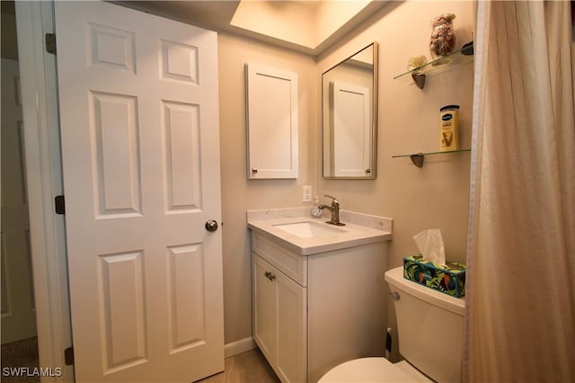 bathroom featuring toilet and vanity